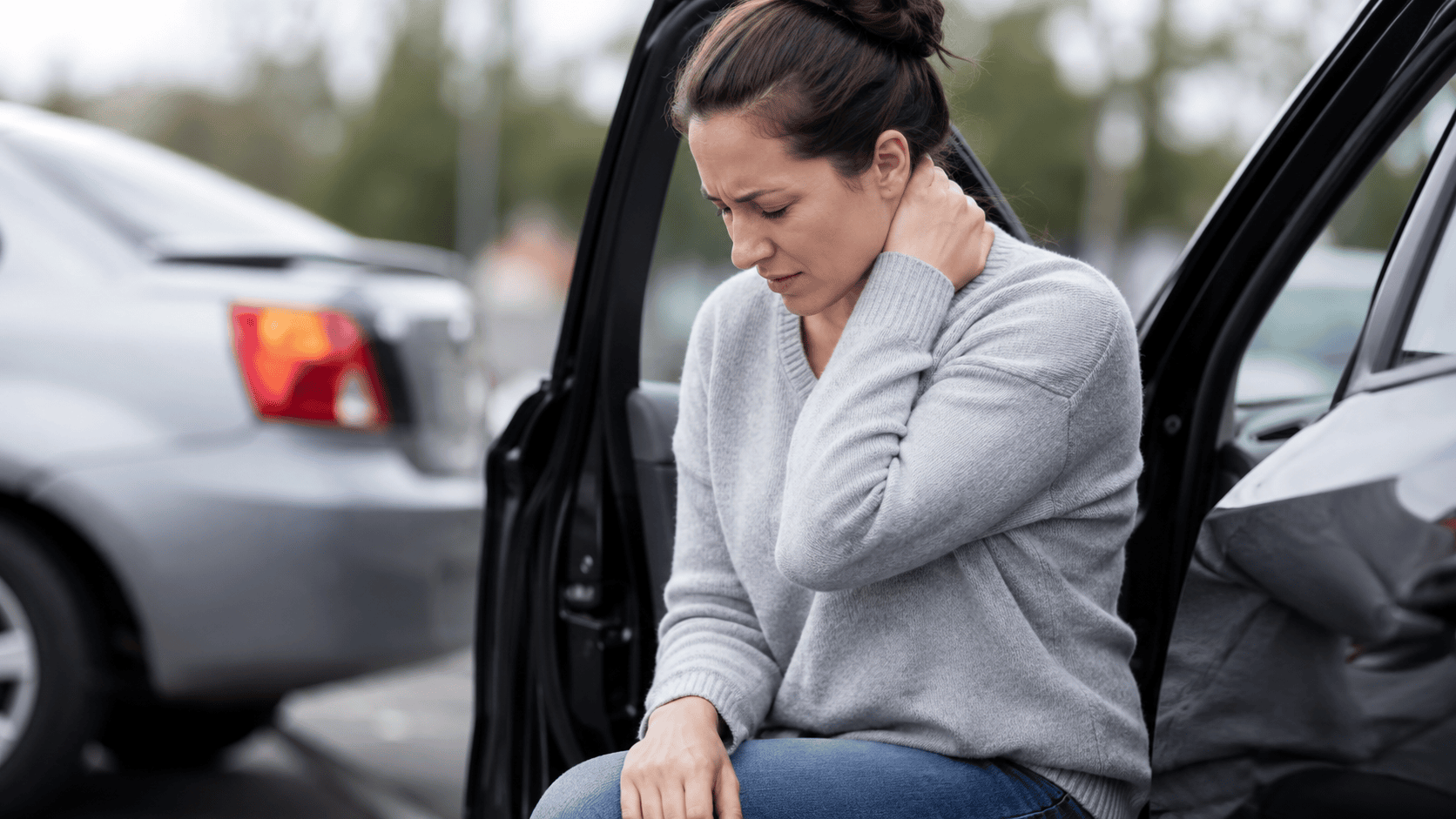 Person experiencing delayed soft tissue pain after a car accident